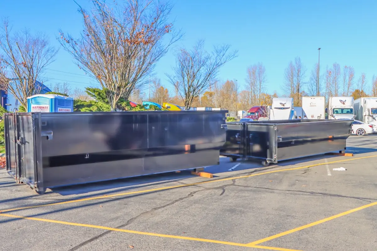 Professional dumpster rental service with roll-off container on residential driveway in Ashton-Sandy Spring